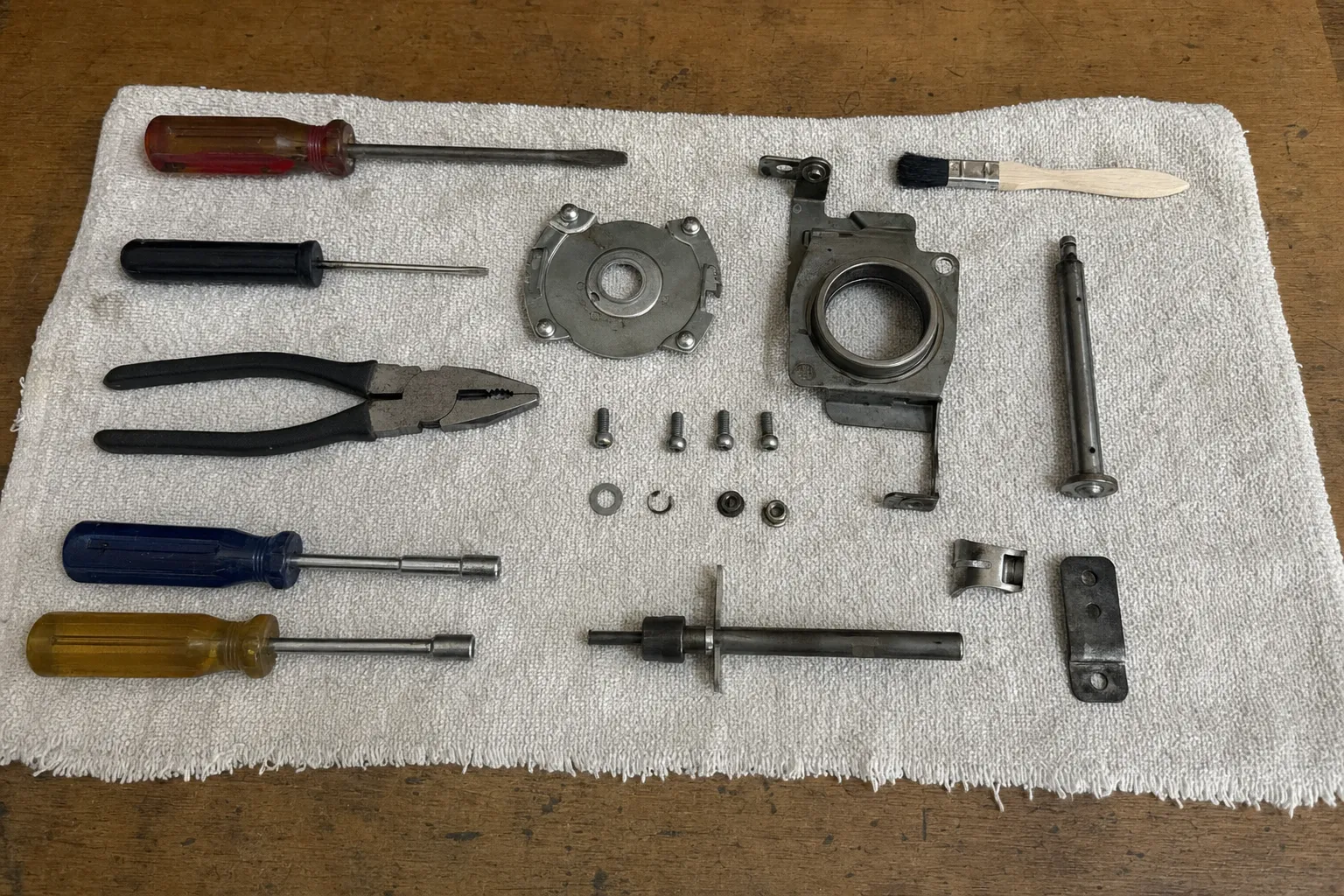 Blower bearing housing, shaft and mounting hardware laid out on a service cloth